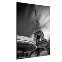 A black and white photograph of the Eiffel Tower in Paris, France, with a blurred background.
