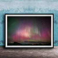 The image is a framed photograph of a night sky with the aurora borealis, or northern lights, visible.
