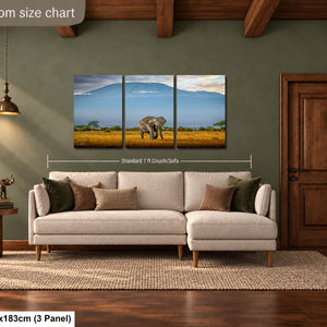 The image is a livingroom size chart that includes a large painting of an elephant in a field, a sofa, a side table, and a door.