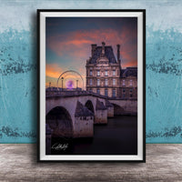 a large, ornate building with a ferris wheel in the background, set against a colorful sunset sky.