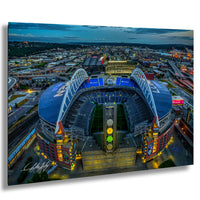 a large stadium with a curved roof and a large field, surrounded by a cityscape at night.