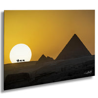 a desert landscape with the iconic pyramids of Giza silhouetted against a vibrant orange and yellow sunset sky.