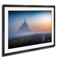 a large, majestic castle or palace in the distance, with a foggy, hazy atmosphere surrounding it. The castle appears to be made of stone and is situated on a hill or elevated platform. A long, winding road or path leads up to the castle, and a fence runs along the side of the road. The sky above is a beautiful blend of blue and orange hues, suggesting either sunrise or sunset. The overall scene conveys a sense of tranquility and grandeur.