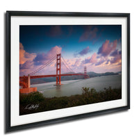 a beautiful sunset over the Golden Gate Bridge, with the iconic red suspension bridge spanning the San Francisco Bay.