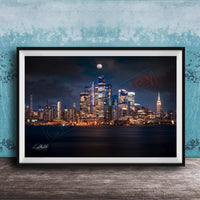 A framed photograph of the New York City skyline at night, with the city's iconic landmarks illuminated against a dark sky.