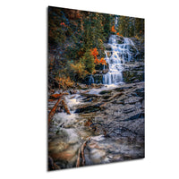 A picturesque waterfall cascading down a rocky cliff surrounded by vibrant autumn foliage.