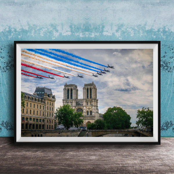 A framed photograph of the French Air Force performing a military air show, with fighter jets flying in formation and leaving trails of smoke in the sky. The backdrop is the iconic Notre-Dame Cathedral in Paris.