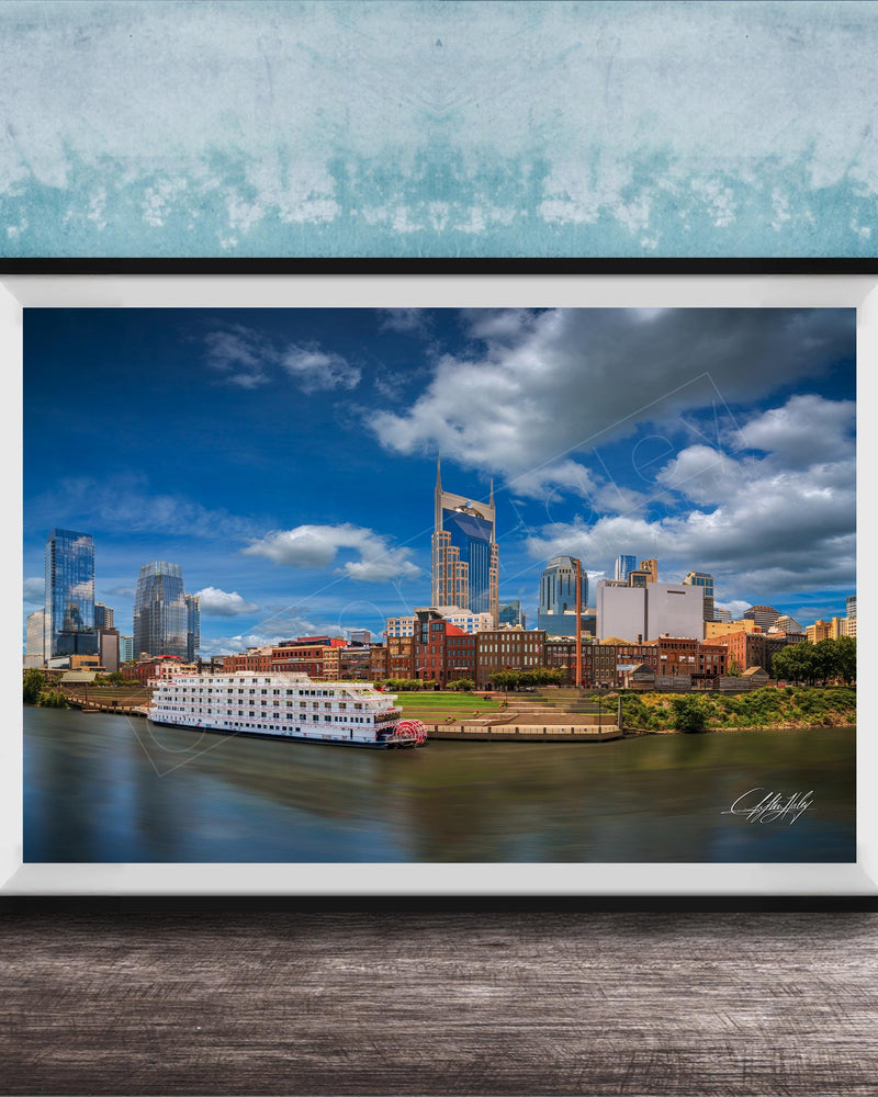 A framed photograph of the Nashville skyline, featuring the iconic skyline of Nashville, Tennessee, with the city's iconic landmarks such as the Tennessee State Capitol and the Nashville River.