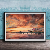 a serene scene of a wooden pier extending into a calm body of water, with a building on the pier and a vibrant sunset sky in the background.