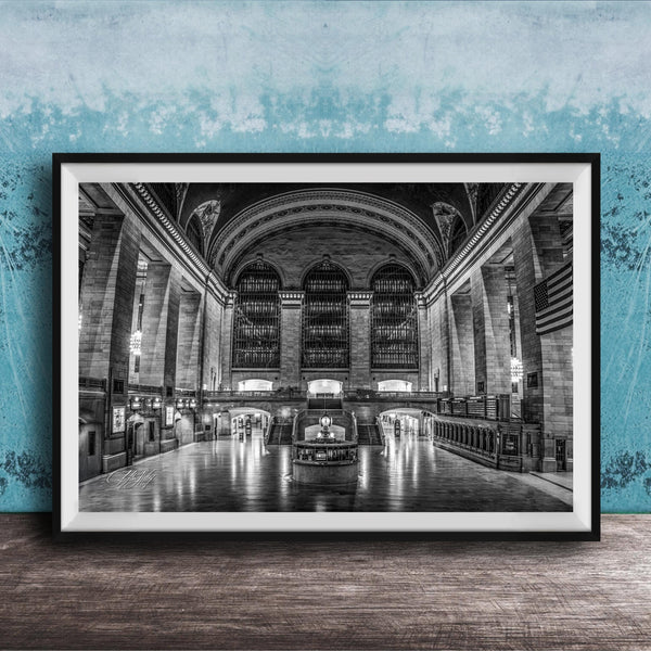 The image is a black and white photograph of a grand, ornate interior space with high ceilings, arched windows, and intricate architectural details.