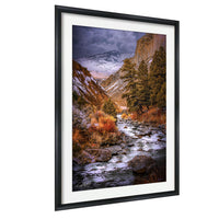 a serene mountain landscape with a winding river flowing through a valley, surrounded by snow-capped peaks and lush vegetation.