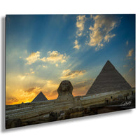 the iconic pyramids of Giza in Egypt, with the Great Sphinx in the foreground and a stunning sunset sky in the background.