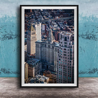The image is a framed aerial view of a cityscape, showcasing a mix of tall buildings and skyscrapers.