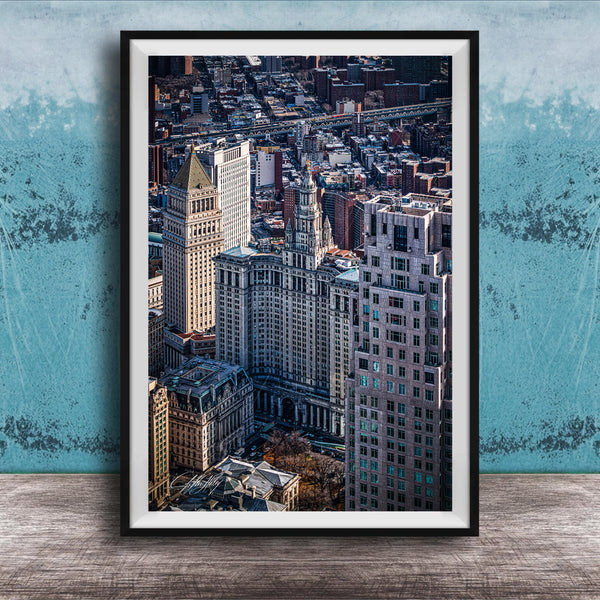 The image is a framed aerial view of a cityscape, showcasing a mix of tall buildings and skyscrapers.