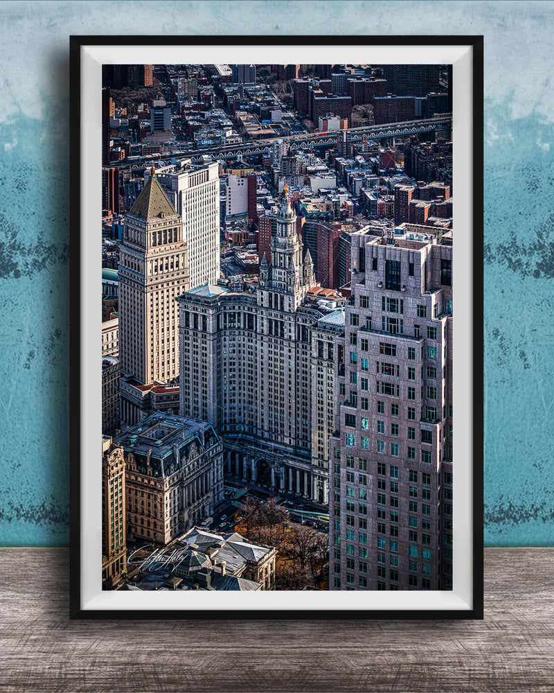 The image is a framed aerial view of a cityscape, showcasing a mix of tall buildings and skyscrapers.