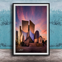 A framed photograph of the Guggenheim Museum in Los Angeles, California, with its distinctive curved architecture and vibrant sunset sky in the background.
