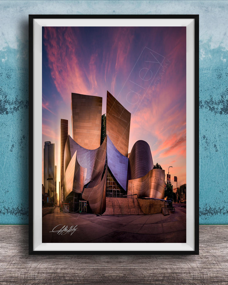A framed photograph of the Guggenheim Museum in Los Angeles, California, with its distinctive curved architecture and vibrant sunset sky in the background.