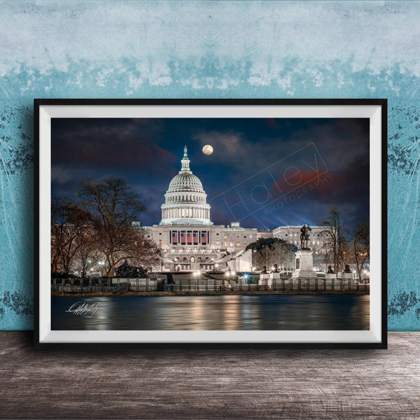 the United States Capitol building at night, with the moon visible in the sky.