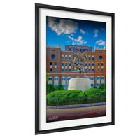 A framed image of a statue of a man on a horse in front of a large brick building with a sign that reads "UNION".