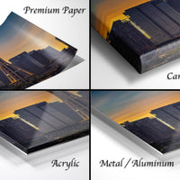 The image is a collage of four different views of a city skyline at sunset, with the cityscape appearing in various materials such as acrylic, metal, and canvas wrap.