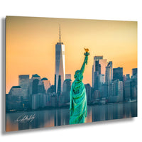 a large statue of the Statue of Liberty in the foreground, with the New York City skyline and the One World Trade Center building in the background.