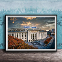 A framed photograph of Yankee Stadium, a baseball stadium located in New York City, with the stadium's name prominently displayed on the exterior.