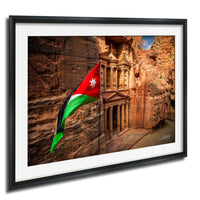 a framed photograph of the ancient ruins of Petra, with the Jordan national flag prominently displayed in the foreground.