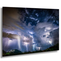 a dramatic and awe-inspiring thunderstorm, with bolts of lightning streaking across the sky and dark, ominous clouds looming overhead.