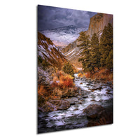 a serene mountain stream flowing through a picturesque landscape, with snow-capped peaks and lush vegetation surrounding the water.