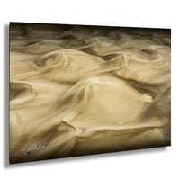 a vast expanse of sand dunes, with their undulating and swirling shapes creating a mesmerizing landscape.