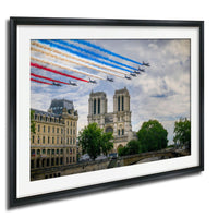 a group of fighter jets flying in formation, leaving trails of smoke behind them, with a large cathedral in the background.