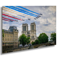 a group of fighter jets flying in formation over a city, with a large cathedral in the background.
