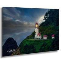 A picturesque lighthouse perched atop a cliff, overlooking the ocean at dusk.