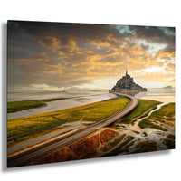 a picturesque scene of a castle on a small island, surrounded by a winding road and a scenic landscape with a dramatic sky and clouds.