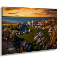 a picturesque harbor scene with a variety of boats docked in the calm waters, surrounded by lush greenery and buildings. The sky is filled with vibrant colors, suggesting a beautiful sunset or sunrise. The image is a collage of multiple images, showcasing the serene atmosphere and the stunning view of the harbor.