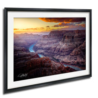 a breathtaking view of the Grand Canyon, with its vast, rugged landscape stretching out beneath a vibrant sunset sky.