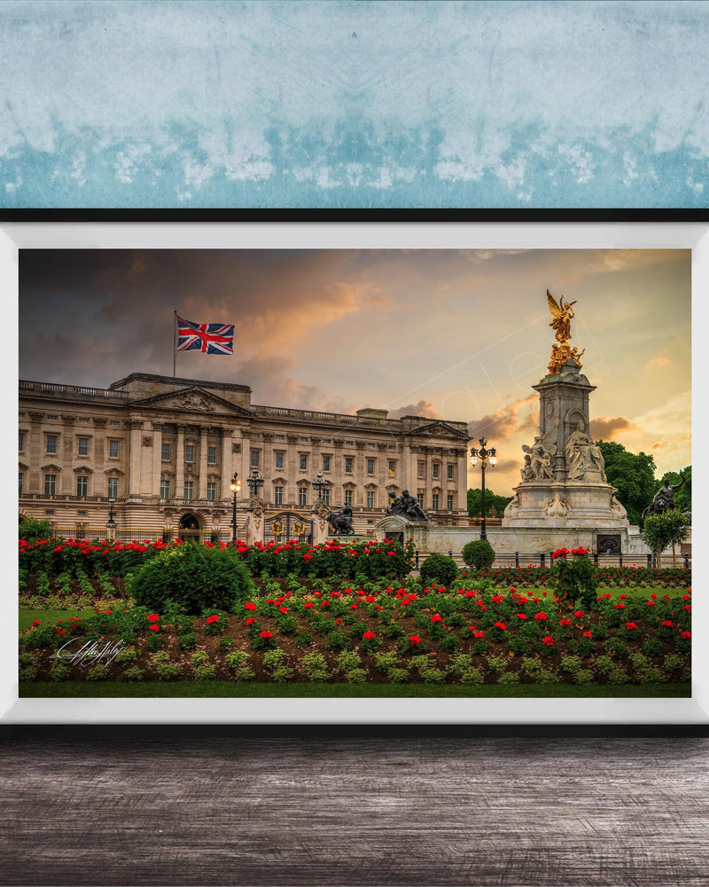 A framed photograph of the Palace of Westminster in London, England, with the British flag flying above the building and a statue in the foreground.