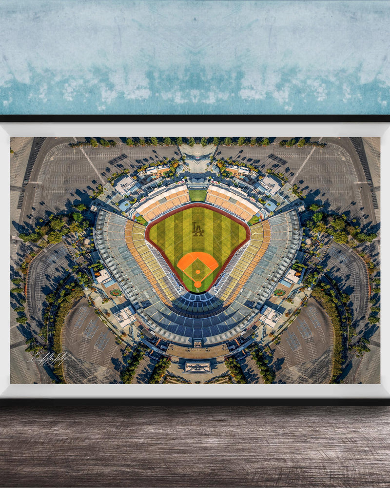 The image is an aerial view of a baseball stadium, featuring a large field surrounded by parking lots and other structures.