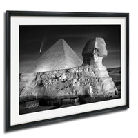 The image is a black and white photograph of the Great Pyramid of Giza and the Sphinx, with a shooting star visible in the sky.