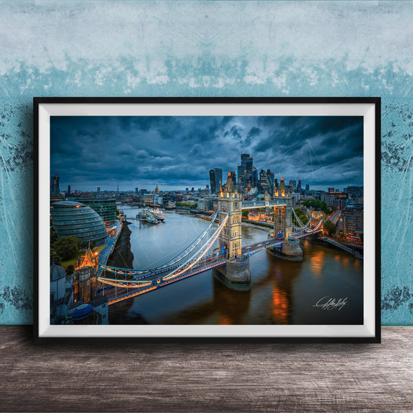 A framed photograph of the London skyline at night, featuring the iconic Tower Bridge and the River Thames.
