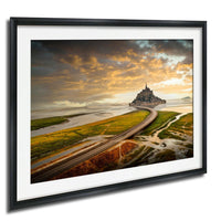 a picturesque landscape with a castle on a hill, surrounded by a winding road and lush green fields. The sky is filled with clouds, creating a dramatic backdrop for the scene.