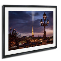 a nighttime cityscape with the Eiffel Tower illuminated against a dark sky.