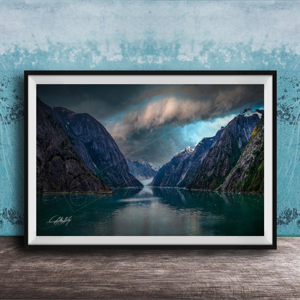 a serene landscape with a calm lake surrounded by towering mountains under a dramatic cloudy sky.