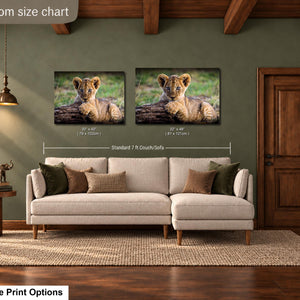 a living room with a large sofa, a wooden door, and a painting of a lion resting on a log. The sofa is positioned in front of the painting, which is hung on the wall above it. The room has a wooden floor and a rug on the floor.