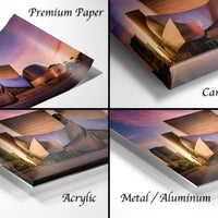 The image is a collage of four different views of a building at sunset, with each view labeled as either "Premium Paper", "Canvas Wrap", "Acrylic", or "Metal/Aluminum".