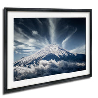 A majestic snow-capped mountain peak emerges from a dramatic cloud formation, creating a striking and awe-inspiring natural landscape.