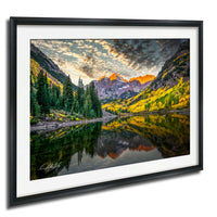 a serene mountain landscape with a lake reflecting the vibrant colors of the surrounding trees and mountains.