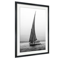 This luxury black and white fine art photograph captures a felucca sail boat drifting along the Nile River at sunset near Luxor, Egypt. Soft fog and minimalist composition create a timeless, monochrome aesthetic rooted in Egyptian river culture. Ideal for collectors and interior designers seeking refined, museum-quality wall art that embodies elegance, simplicity, and enduring calm.
