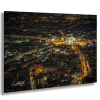 a bustling cityscape at night, with numerous illuminated buildings and streets creating a vibrant and lively atmosphere.