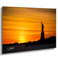 a silhouette of the Statue of Liberty against a vibrant sunset sky.